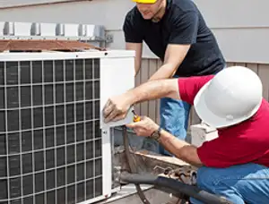 HVAC technicians repairing an outdoor AC unit on a rooftop in Tacoma, WA